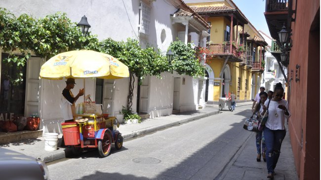 Im historischen Stadtkern Cartagenas: Passanten suchen Schutz vor der Mittagssonne, ein Limonadeverkäufer wartet auf Kunden.